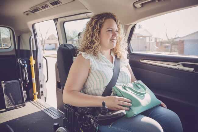 Senior woman with disability using accessible transportation vehicle